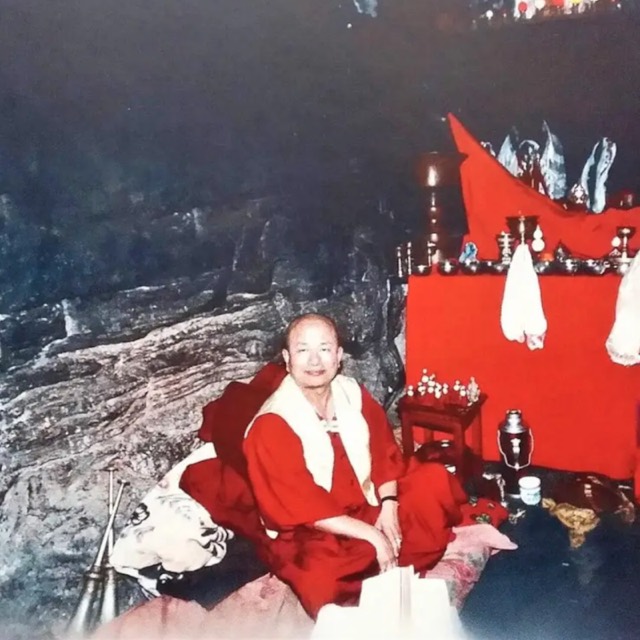 The Grandmaster in red robes at an outdoor ceremony during the years of seclusion
