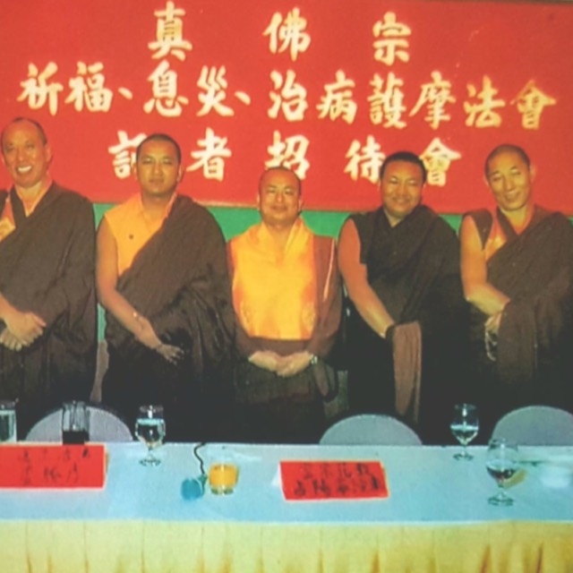 Masters seated beneath the banner of a True Buddha School blessing, healing and longevity ceremony